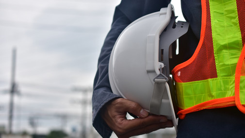 Bauarbeiter mit Helm unterm Arm